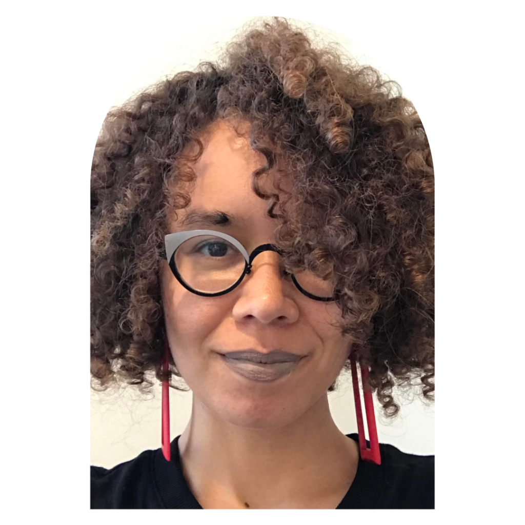 An arched photo of Ianna Hawkins Owen with brown almost chin length curly hair, long fuchsia geometric earrings, brown-grey lipstick, and grey and black glasses